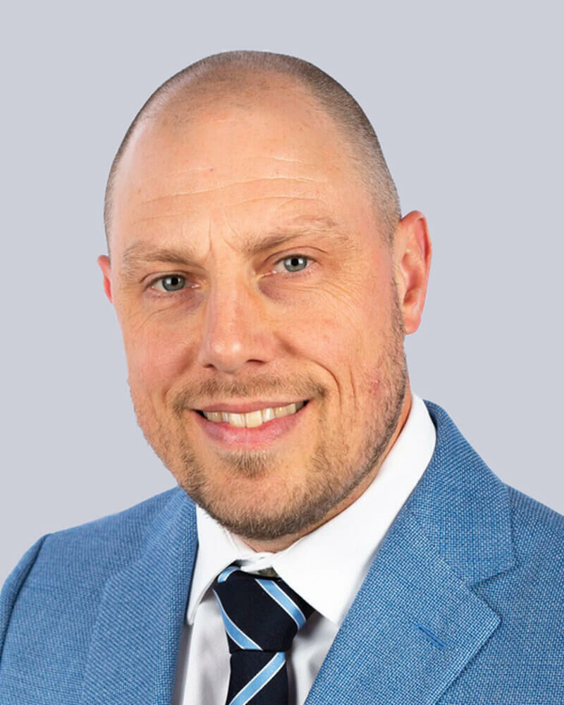 Studio portrait of King's InterHigh SEN Lead, Ray Boxall, against a white background.